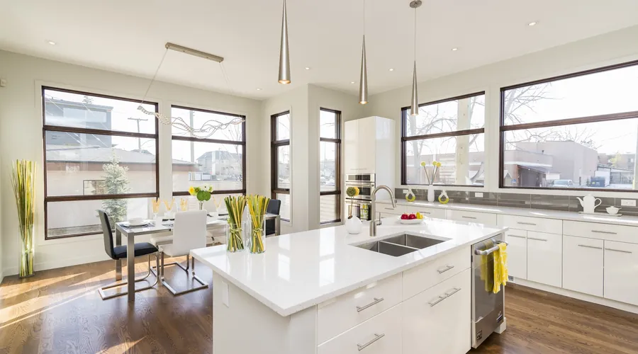 Bright modern kitchen with an island and a dining area beyond