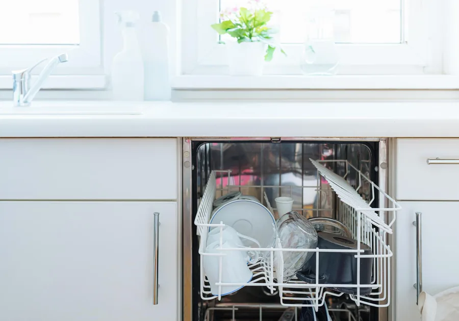 Open dishwasher loaded with clean dishes in a modern kitchen