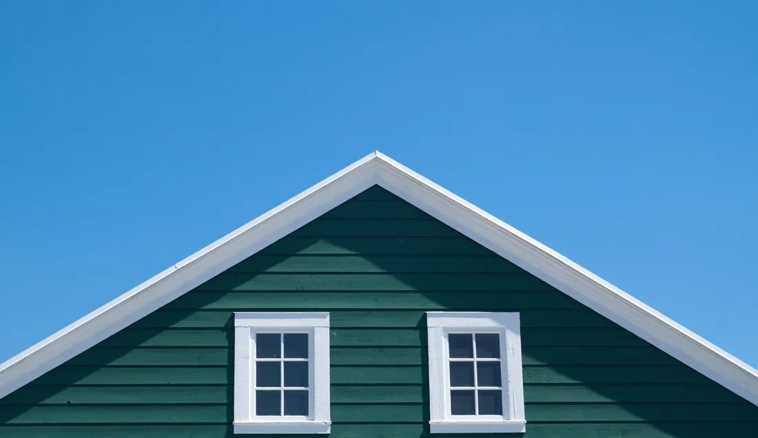 Gable of a suburban family home against a clear sky